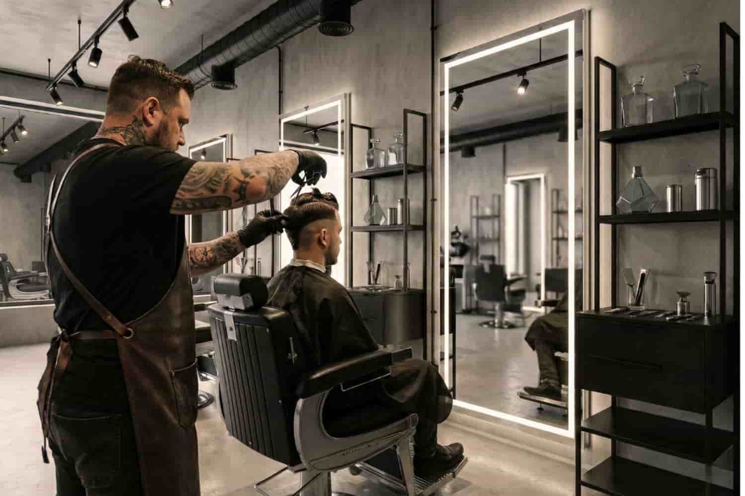 Barbero experto realizando corte de cabello con tijera y texturizado para hombre en Ecatepec de Morelos.